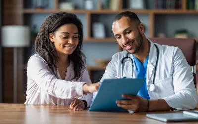 Two healthcare professionals reviewing a medical report on a tablet together